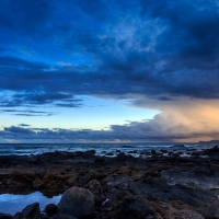 Blue Clouds Above the Rocky Beach