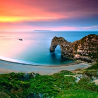 Cliff Arch By The Water At Sunset