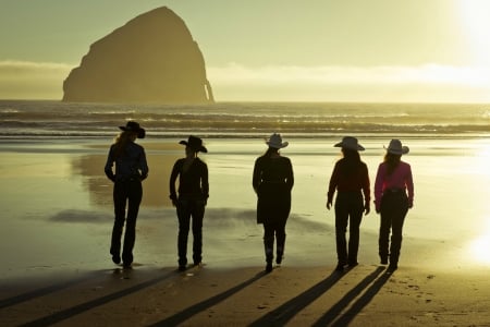 A Walk On The Beach - rock, water, beach, hats, cowgirls, ocean, sand, clouds, waves