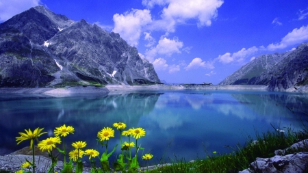 Calmness Lake - lake, shore, mirrored, mountains, peaks, rocks, nature, calmness, blue, clouds, flowers