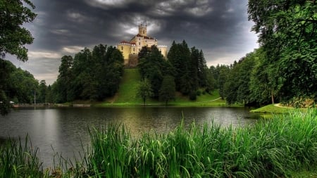 Hilltop Castle - clouds, trees, hills, reeds, stormy, grass, river, nature, castle