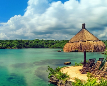 Straw Umbrella and Sun Beds on the Shore - nature, sky, beach, clouds, sun, shore, sea