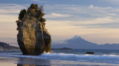 Sea Stack and Mount Taranaki,New Zealand - nature, beach, water, mountains, rocks, waves