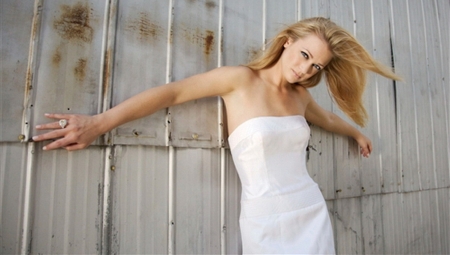 AJ Cook - white dress, posing against wall, blonde, ring on finger, strapless