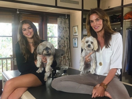 Kaia Gerber and mother Cindy Crawford - lare window, hanging clothes, two dogs, short dress kaia, brunette, white blouse and faded jeans cindy