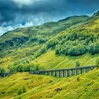 Railway Bridge in Grassy Mountain Landscape