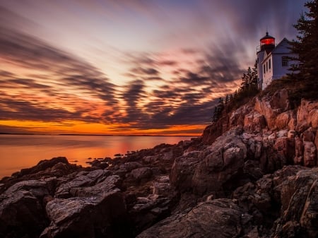 Lighthouse at Sunset - clouds, sunset, nature, lighthouse, park, rocks, sky