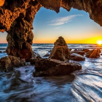 Sea Sunrise over Rock Cave