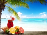 Cocktail and tropical fruits on the beach