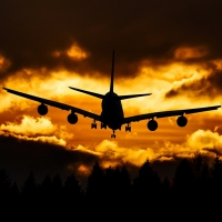 Airplane in the clouds of sunset