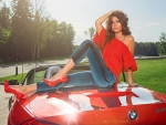 Anna Kasterova Sitting on a Red BMW Z4