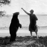 Feeding a bear circa 1925