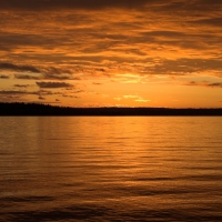 Golden sunset on calm golden lake