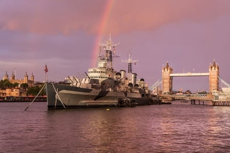 WORLD OF WARSHIPS  HMS Belfast  part of the Imperial War Museum, London UK - cruiser, tower bridge, rainbow, early evening, camoflage scheme, river thames