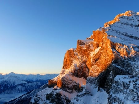 Morning Sun on Top of a Snowy Mountain