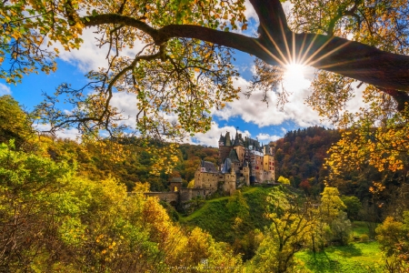 Autumn sun over Eltz castle, Germany - branches, rays, autumn, trees, mountain, glow, fall, beautiful, castle, germany