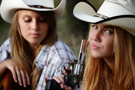 This Thing Is Hot . . - women, fun, female, hats, models, weapons, western, pistols, girls, cowgirl, style, outdoors, NRA, blondes, ranch