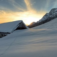 Hut Covered with Snow on the Roof