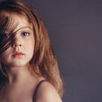 Little girl with peacock feather