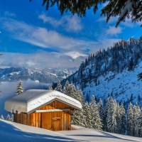 Wooden cottage in winter mountain