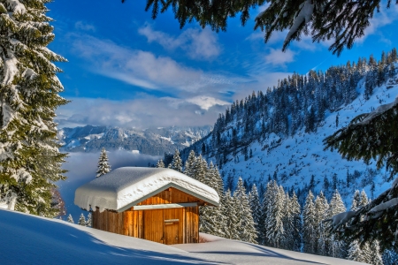 Wooden cottage in winter mountain