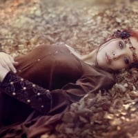 Redhead Lying On Autumn Leaves