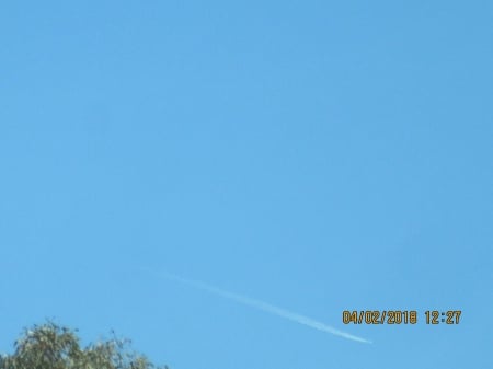 This was moving so quickly - long trail behind it, spied in the blue sky, moving very fast, very mysterious