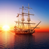 pirate ship in the sea at sunset