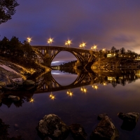 Lights Reflected on River Bridge at Dusk