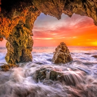 Malibu beach sea cave sunset
