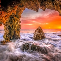 Malibu beach sea cave sunset