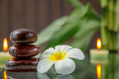 Spa background - candle, flower, stones, plumeria