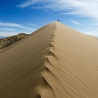 Tourist atop the Singing Sand Dunes