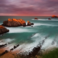 Rocky Coast of the Ocean in Cloudy at sunset