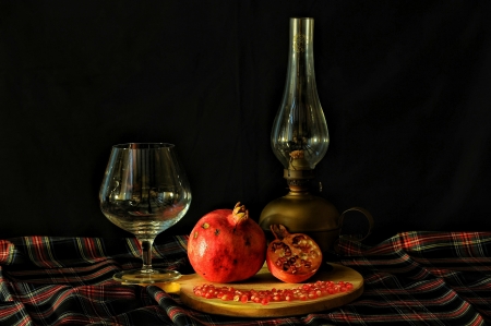 Still life - table, glass, lamp, pomegranate