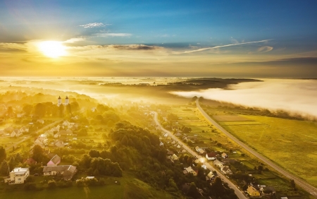 Aerial View of Sunbeams over Foggy Landscape