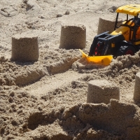 Toy Excavator in Sand