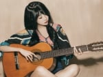 Asian girl playing the guitar