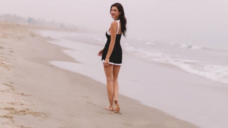 Brunette on the beach - black dress, beach, barefoot, brunette, sea, feet, legs