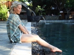 Woman sitting on the edges of the pool