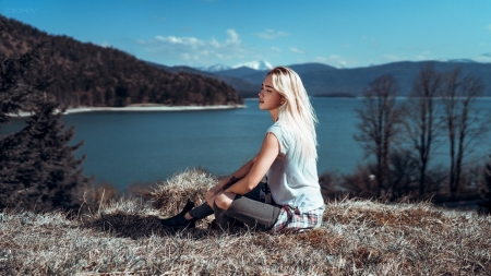 Blonde Enjoying a Rest - loose t shirt, jeans, trees headland, bag, overlooking lake, blonde