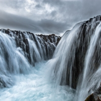 Dark Clouds over Rocky Waterfalls