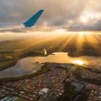 Airplane over small town at dusk