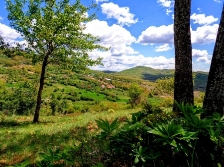 beautiful spring landscape - mountains, sky, houses, trees