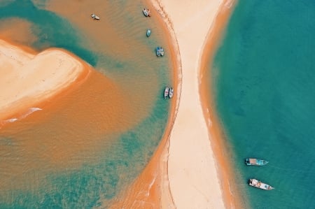 Sand, boats, ocean from above