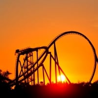 Roller coaster backdropped by sunset during golden hour