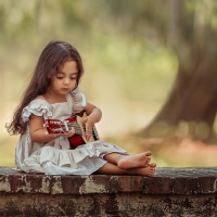 Little girl playing guitar