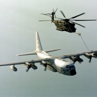 A USMC C-130 refuels a CH-53 Helicopter