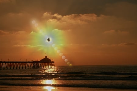 Beachside Eclipse - eclipse, ocean, beach, pier, surf, clouds, sun, sunset