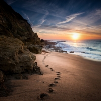 Footprints in the sand on a lonely beach